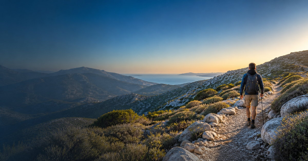 Hiker on a Greek mountain trail overlooking the Aegean Sea